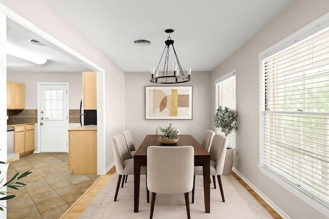 2301 Westworth Cir, Austin, TX 78704 - dining room with plenty of natural light, a chandelier, and light wood-style flooring