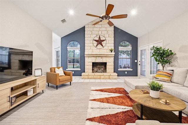 220 Meadow Oaks Dr, Dripping Springs, TX 78620 - living area with a stone fireplace, high vaulted ceiling, ceiling fan, and wood finished floors