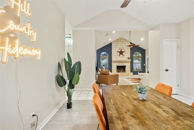 220 Meadow Oaks Dr, Dripping Springs, TX 78620 - dining room with vaulted ceiling, ceiling fan, tile patterned floors, and a fireplace
