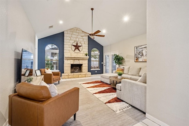 220 Meadow Oaks Dr, Dripping Springs, TX 78620 - living room with a ceiling fan, healthy amount of natural light, a stone fireplace, high vaulted ceiling, and wood finished floors