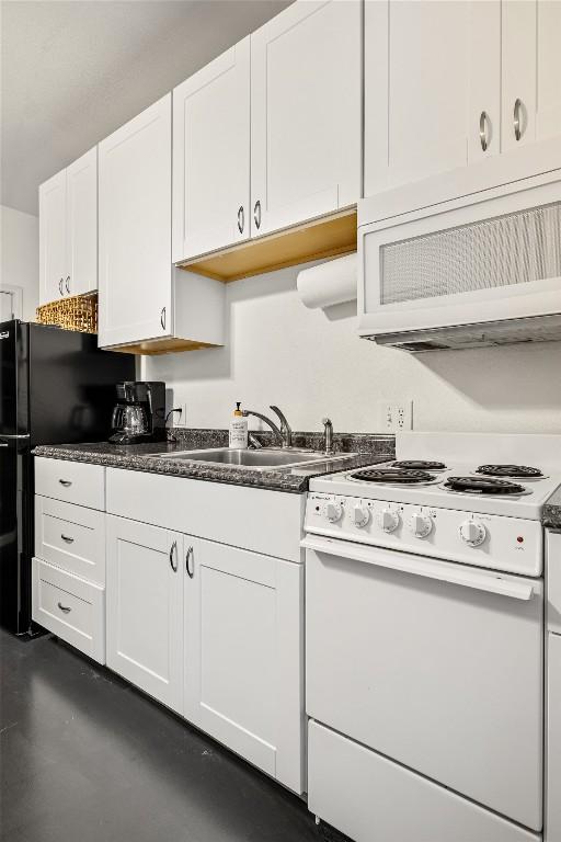 220 Meadow Oaks Dr, Dripping Springs, TX 78620 - kitchen with white appliances, dark countertops, white cabinets, and finished concrete floors