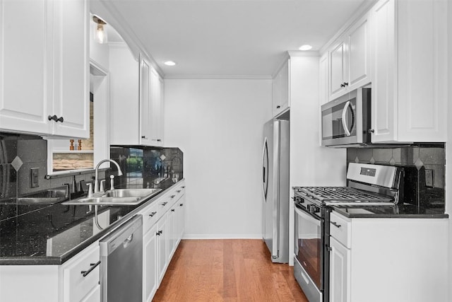 2601 Ashdale Dr, Austin, TX 78757 - kitchen featuring stainless steel appliances, recessed lighting, white cabinets, tasteful backsplash, and light wood-style flooring