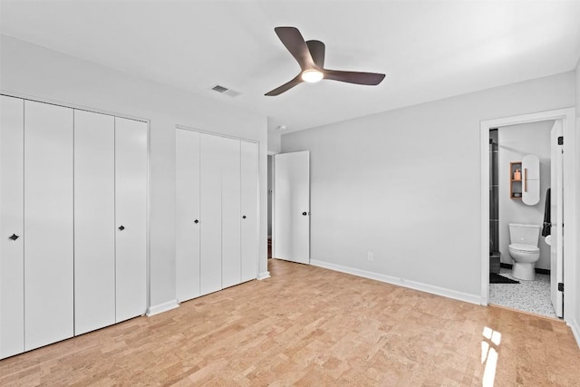 2601 Ashdale Dr, Austin, TX 78757 - unfurnished bedroom featuring multiple closets, ensuite bathroom, and ceiling fan