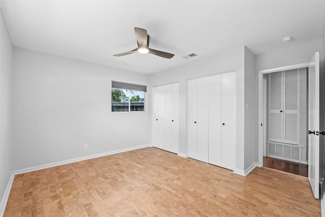 2601 Ashdale Dr, Austin, TX 78757 - unfurnished bedroom featuring two closets and a ceiling fan