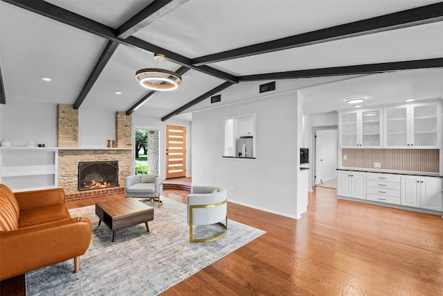 2601 Ashdale Dr, Austin, TX 78757 - living room featuring light wood-style flooring, a stone fireplace, and recessed lighting