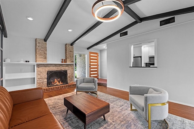 2601 Ashdale Dr, Austin, TX 78757 - living room featuring wood finished floors, a stone fireplace, and recessed lighting