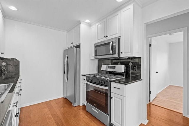 2601 Ashdale Dr, Austin, TX 78757 - kitchen with stainless steel appliances, light wood-type flooring, dark countertops, white cabinets, and recessed lighting