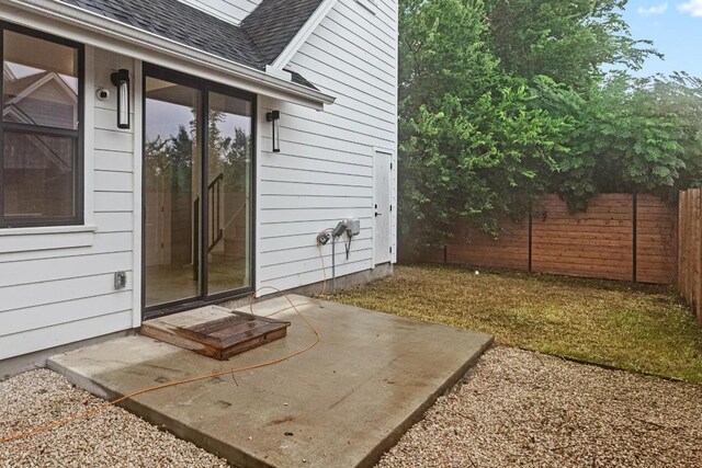 7706 Watson St Unit 2, Austin, TX 78757 - view of exterior entry featuring a patio area and roof with shingles