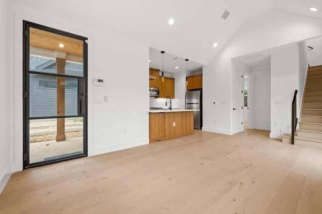 7706 Watson St Unit 2, Austin, TX 78757 - unfurnished living room with stairway, light wood-type flooring, recessed lighting, and lofted ceiling