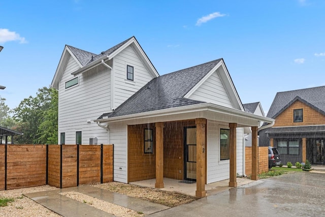7706 Watson St Unit 2, Austin, TX 78757 - view of front of home featuring a shingled roof and a porch