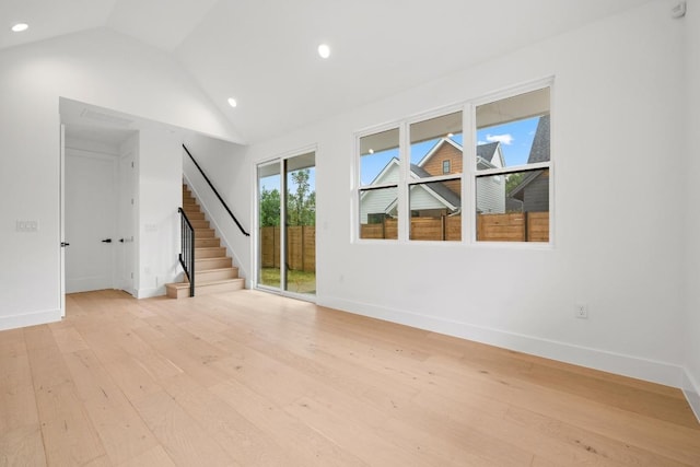7706 Watson St Unit 2, Austin, TX 78757 - unfurnished living room with stairway, light wood finished floors, recessed lighting, and high vaulted ceiling