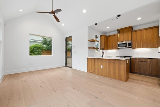 7706 Watson St Unit 2, Austin, TX 78757 - kitchen featuring stainless steel microwave, brown cabinets, open shelves, modern cabinets, and recessed lighting