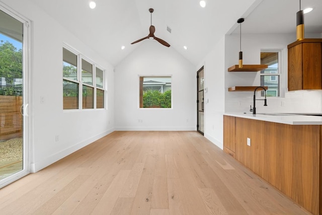 7706 Watson St Unit 2, Austin, TX 78757 - unfurnished living room with light wood-style floors, plenty of natural light, a ceiling fan, recessed lighting, and lofted ceiling