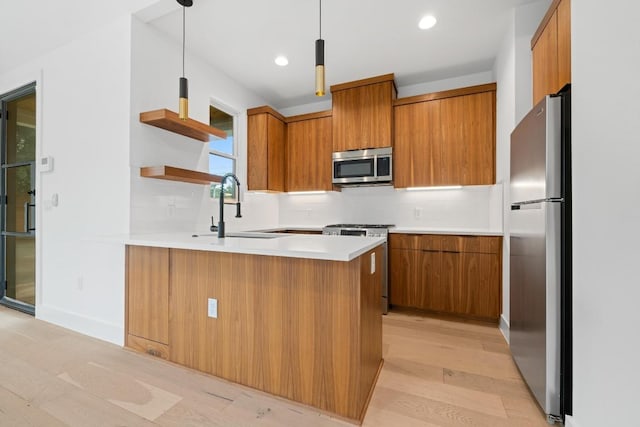 7706 Watson St Unit 2, Austin, TX 78757 - kitchen featuring stainless steel appliances, brown cabinetry, tasteful backsplash, a peninsula, and open shelves