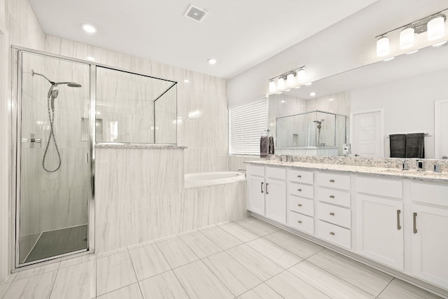 16713 Elsinore Ln, Pflugerville, TX 78660 - full bathroom with a garden tub, double vanity, tile patterned floors, and a shower stall