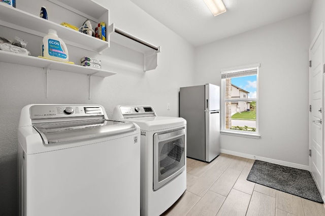 16713 Elsinore Ln, Pflugerville, TX 78660 - washroom with separate washer and dryer and wood finish floors