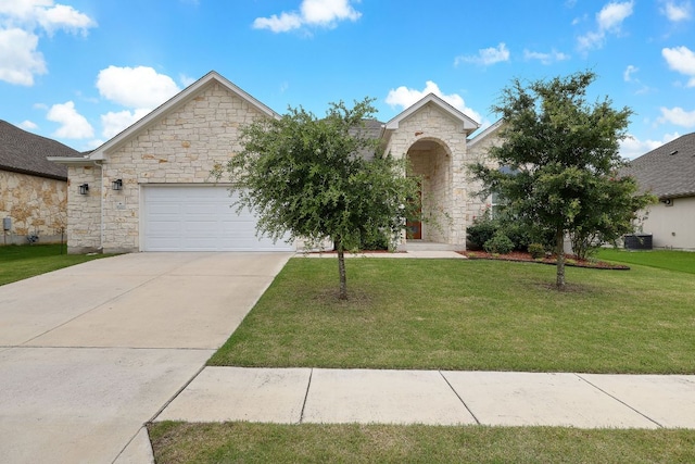 16713 Elsinore Ln, Pflugerville, TX 78660 - view of front facade featuring stone siding, an attached garage, a front yard, and concrete driveway