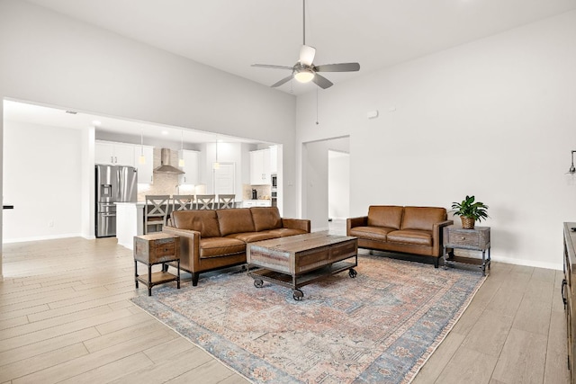 16713 Elsinore Ln, Pflugerville, TX 78660 - living area with ceiling fan, light wood finished floors, and a towering ceiling