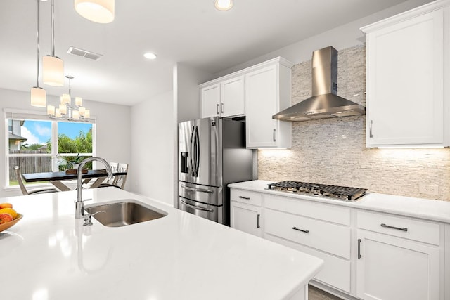 16713 Elsinore Ln, Pflugerville, TX 78660 - kitchen with wall chimney range hood, appliances with stainless steel finishes, tasteful backsplash, light countertops, and recessed lighting
