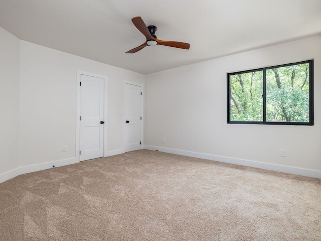 6000 Roxbury Ln, Austin, TX 78739 - unfurnished bedroom with carpet flooring, two closets, and a ceiling fan