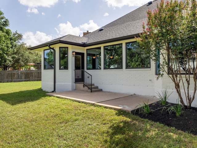 6000 Roxbury Ln, Austin, TX 78739 - rear view of house with brick siding, a patio area, a chimney, and roof with shingles