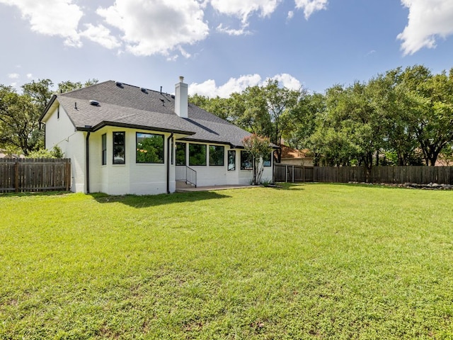 6000 Roxbury Ln, Austin, TX 78739 - back of house with a fenced backyard, roof with shingles, a chimney, and brick siding