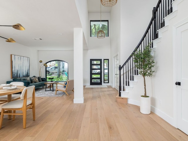 6000 Roxbury Ln, Austin, TX 78739 - foyer entrance with plenty of natural light, light wood-style floors, stairway, a high ceiling, and a chandelier