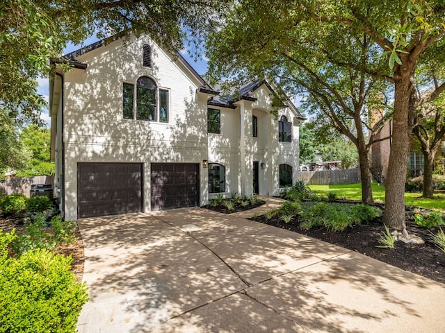 6000 Roxbury Ln, Austin, TX 78739 - french country style house featuring a garage and concrete driveway