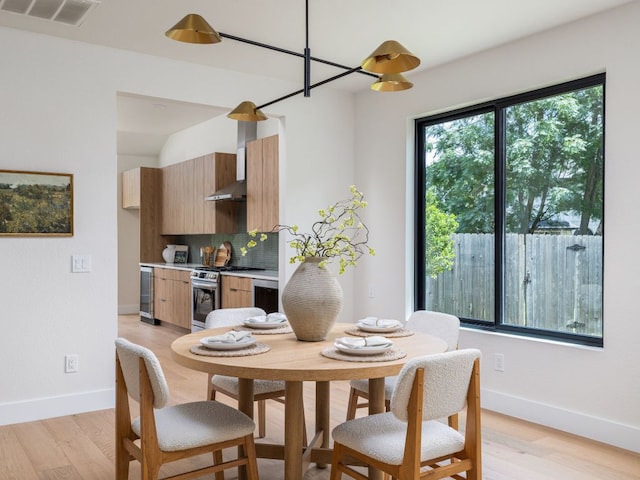 6000 Roxbury Ln, Austin, TX 78739 - dining area featuring light wood finished floors and wine cooler
