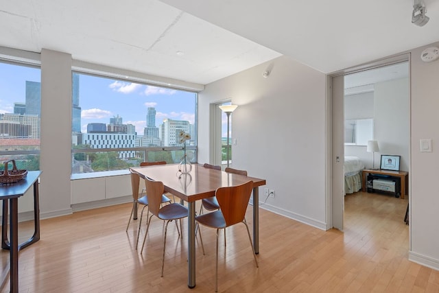 1212 Guadalupe St Unit 805, Austin, TX 78701 - dining room with light wood-style flooring, a skyline view, and plenty of natural light