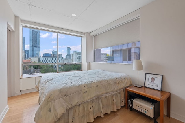 1212 Guadalupe St Unit 805, Austin, TX 78701 - bedroom with wood finished floors and a skyline view