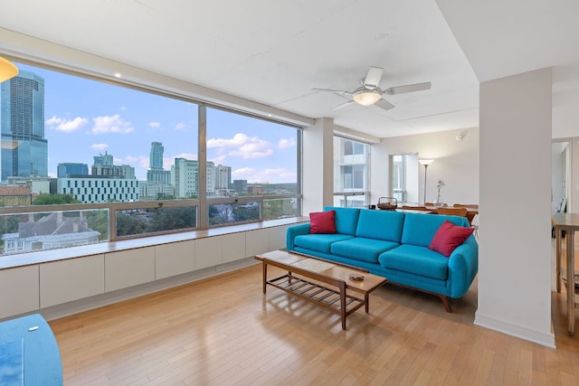 1212 Guadalupe St Unit 805, Austin, TX 78701 - living room with light wood-style flooring, a ceiling fan, and a city view