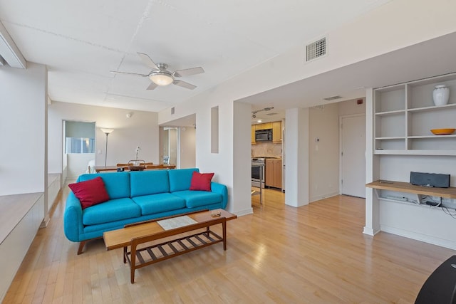 1212 Guadalupe St Unit 805, Austin, TX 78701 - living room featuring light wood-style floors, a ceiling fan, and an office area