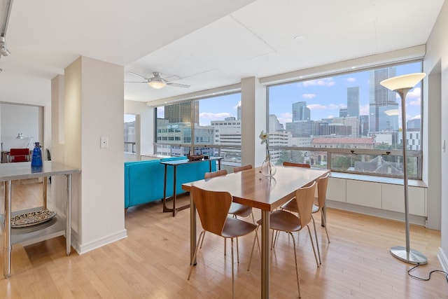 1212 Guadalupe St Unit 805, Austin, TX 78701 - dining room with light wood finished floors, a view of skyline, and ceiling fan