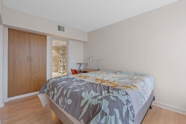 1212 Guadalupe St Unit 805, Austin, TX 78701 - bedroom featuring wood finished floors and baseboards
