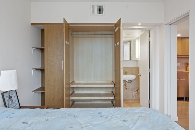 1212 Guadalupe St Unit 805, Austin, TX 78701 - bedroom featuring ensuite bath and a sink