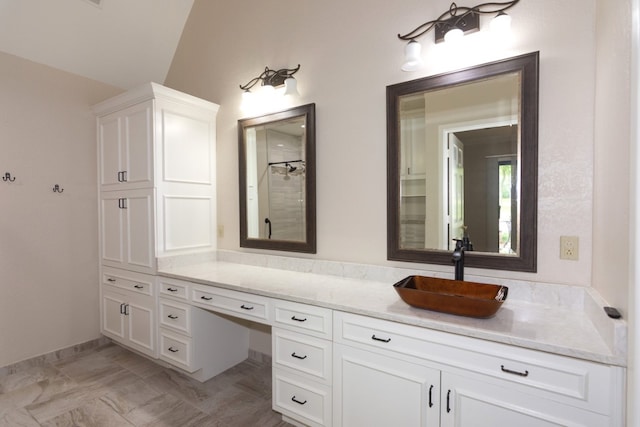 1404 Pearl Cv, Round Rock, TX 78681 - bathroom featuring vanity, lofted ceiling, and a shower