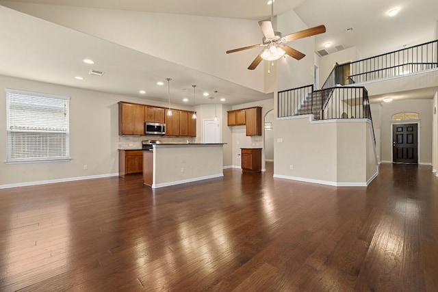 605 Joppa Rd, Leander, TX 78641 - unfurnished living room featuring a ceiling fan, high vaulted ceiling, dark wood-style floors, stairs, and recessed lighting