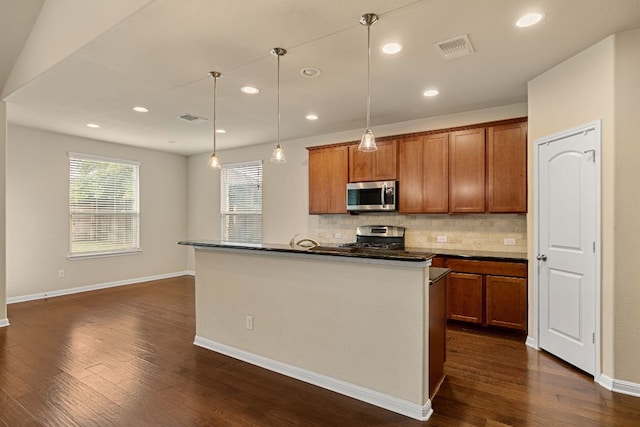 605 Joppa Rd, Leander, TX 78641 - kitchen with stainless steel appliances, dark countertops, tasteful backsplash, dark wood finished floors, and recessed lighting