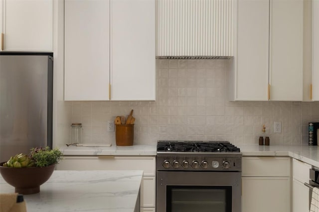 1206 Cloverleaf Dr, Austin, TX 78723 - kitchen featuring appliances with stainless steel finishes, white cabinets, and tasteful backsplash