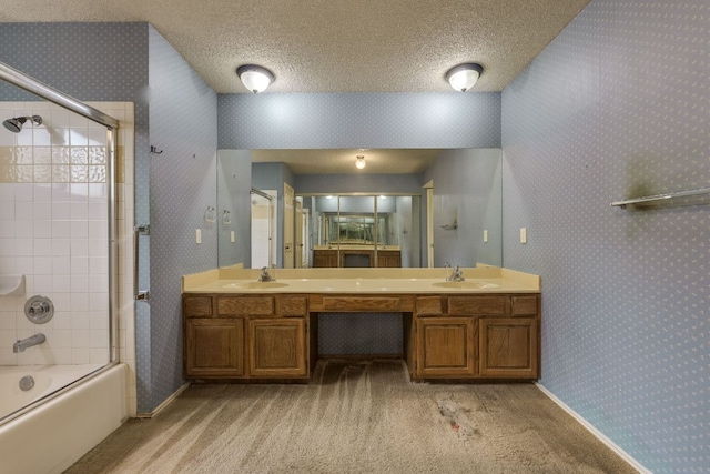 13102 Amarillo Ave, Austin, TX 78729 - bathroom with double vanity, enclosed tub / shower combo, wallpapered walls, and a textured ceiling