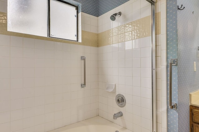 13102 Amarillo Ave, Austin, TX 78729 - bathroom with wallpapered walls, bath / shower combo with glass door, and vanity