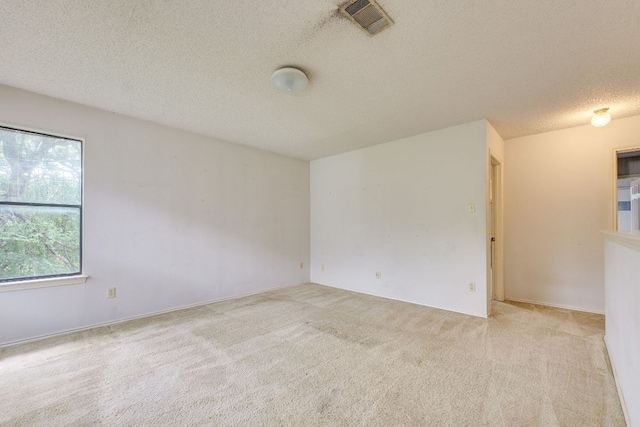 13102 Amarillo Ave, Austin, TX 78729 - carpeted empty room with a textured ceiling