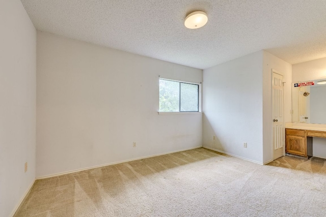 13102 Amarillo Ave, Austin, TX 78729 - unfurnished bedroom with light carpet and a textured ceiling