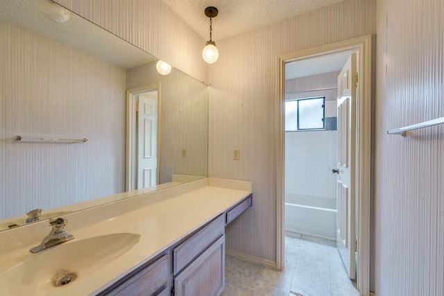 13102 Amarillo Ave, Austin, TX 78729 - full bathroom with vanity, a textured ceiling, and tile patterned flooring