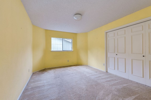 13102 Amarillo Ave, Austin, TX 78729 - unfurnished bedroom featuring carpet floors, a textured ceiling, and a closet