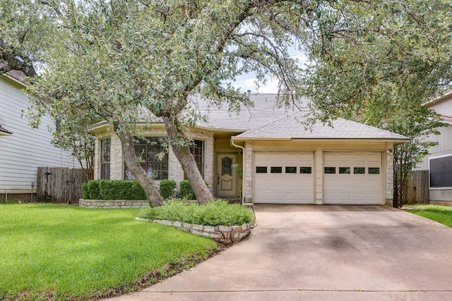 13102 Amarillo Ave, Austin, TX 78729 - view of front of house featuring concrete driveway, an attached garage, stone siding, and roof with shingles