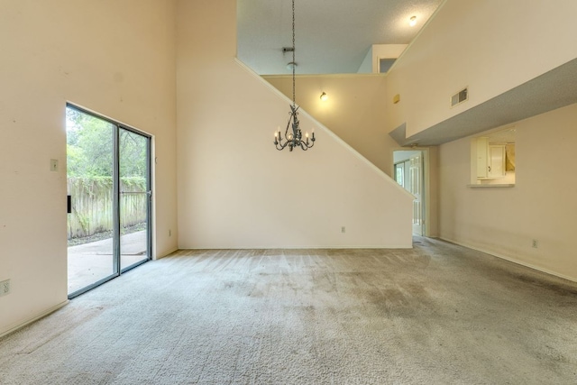 13102 Amarillo Ave, Austin, TX 78729 - unfurnished living room featuring a high ceiling, light carpet, and a chandelier