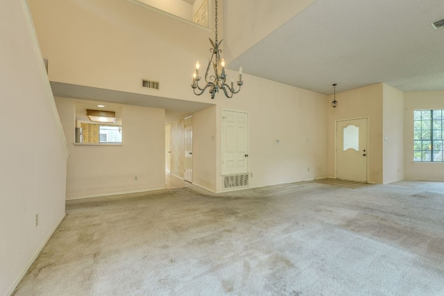 13102 Amarillo Ave, Austin, TX 78729 - unfurnished living room featuring carpet floors, a chandelier, and a towering ceiling