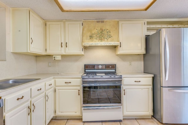 13102 Amarillo Ave, Austin, TX 78729 - kitchen featuring appliances with stainless steel finishes, custom exhaust hood, light tile patterned floors, and light countertops